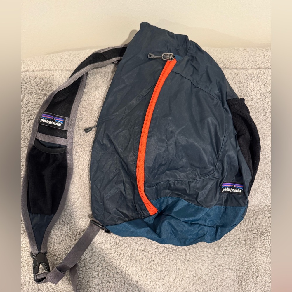 Patagonia Dark Blue Sling Bag with Orange Zipper